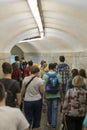 People silhouettes in a subway tunnel. Crowd walking in a corridor