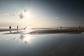 People silhouettes on summer beach in sunshine