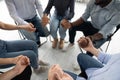 People sitting in circle holding hands involved at group therapy Royalty Free Stock Photo