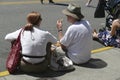 People sit on the curb to eat fast food Royalty Free Stock Photo