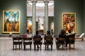 People sit in hall in Pinacoteca di Brera in Milan