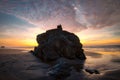 People sit on rock watching dramatic sunset at Oregon coast. Royalty Free Stock Photo
