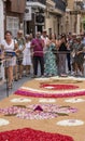 People during Sitges Corpus Christi at a flower carpet in Sitges, Spain