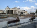 People sits on benches in Skopje in North Macedonia.