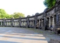 People sitting along a wall in Koblenz, Germany