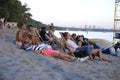 People sitting on a beach and sunbathing evening sun light. Fest of Yoga and Vedic Culture Vedalife-2018 Royalty Free Stock Photo