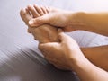 People suffering with foot pain use hand to massage toe, leg, ankle and soles to relax and relieve pain Royalty Free Stock Photo