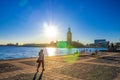 People are sitting on bench at promenade embankment of Lake Malaren looking at Stockholm City Hall Stadshuset Royalty Free Stock Photo