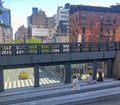 People Sitting on Benches of the High Line Park with a view of Chelsea neighborhood