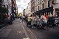 People sitting on the busy restaurant terrace in Soho area during Coronavirus lockdown ease