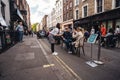 People sitting on the busy restaurant terrace in Soho area during Coronavirus lockdown ease