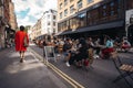 People sitting on the busy restaurant terrace in Soho area during Coronavirus lockdown ease