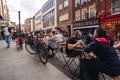 People sitting on the busy restaurant terrace in Soho area during Coronavirus lockdown ease
