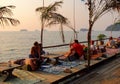 People sitting at the coffee shop near the sea in Krabi, southern Thailand