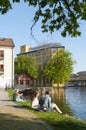 People sitting on the embankment to Motala stream Royalty Free Stock Photo