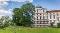 People sitting in the grass in front of the castle of Celle