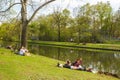 People sitting on the ground. Rest at the park. Picnic. Friends meeting. Family time.