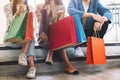 People sitting and holding shopping bags together Royalty Free Stock Photo
