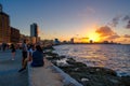 People sitting on the malecon seawall in Havana during a beautiful sunset Royalty Free Stock Photo