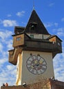 People are sitting nearly city Clock tower in Graz Royalty Free Stock Photo