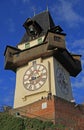 People are sitting nearly city Clock tower in Graz Royalty Free Stock Photo