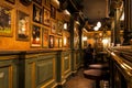 People sitting in nice restaurant with vintage interiors, old paintings, decorations and bar counter