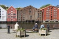 People sitting by Nidelv river Trondheim Royalty Free Stock Photo