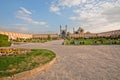 People sitting and relaxing on the green grass of famouse Imam Square