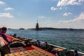 People sitting at seaside on the steps with the view on the Maiden`s Tower, Istanbul, Turkey Royalty Free Stock Photo