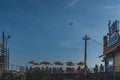 People sitting in seatings under umbrellas next to Nathan`s famous hotdogs restaurant under blue sky, in Coney Island Royalty Free Stock Photo