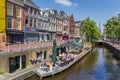 People sitting in the sun at a canal in Leeuwarden Royalty Free Stock Photo