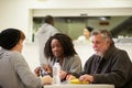 People Sitting At Table Eating Food In Homeless Shelter Royalty Free Stock Photo