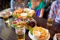 People sitting at table with food and beer at bar Royalty Free Stock Photo