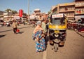 People sitting at traditional rickshaw taxi cabs