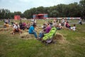 People sitting waiting for a concert at the stadium against the background of the main scene of the Intl festival