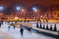 People skate in the evening in the Park in winter. Royalty Free Stock Photo