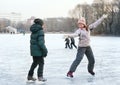 People skating on the pond surface in russian park