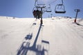 People on ski chair lift in sunny winter Alps in Austria