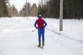 People ski in winter on a ski track through a winter forest.Cross Country skiing