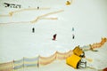 People skiing down a wide track for beginners in Bukovel, Ukraine