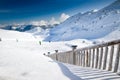 People skiing on the prepared slope with fresh new powder snow i