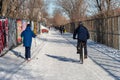 People skiing or riding bike after snowfall in Montreal