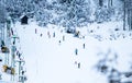 People skiing on slopes in winter scenery in Kranjska Gora in Julian Alps, Slovenia