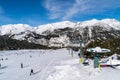 People skiing and snowboarding in Slopes of Grandvalira ski area of Pyrenees Mountains in Andorra