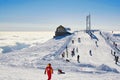 People skiing on top of Carpathian Mountains, Romania with mountain rescue in sight