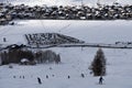 People sking snowboarding down the slope. Town of Livigno in winter. Livigno landscapes in Lombardy, Italy, located in the Italian