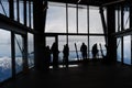 People with skis as silhouettes wait in the ropeway or cable car station for the gondola on the Zugspitze, the highest mountain of Royalty Free Stock Photo