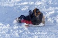 People sledding from the mountain in winter Royalty Free Stock Photo
