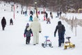 People with sledge climbing at the snowy hill on winter park in Bakuriani Royalty Free Stock Photo