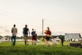 People In Slow Motion Walking Across a Green Space